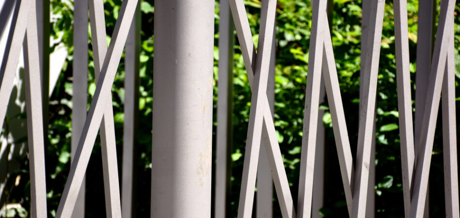 Modern,powder,coated,aluminum,fence,detail.,lush,green,foliage,background.